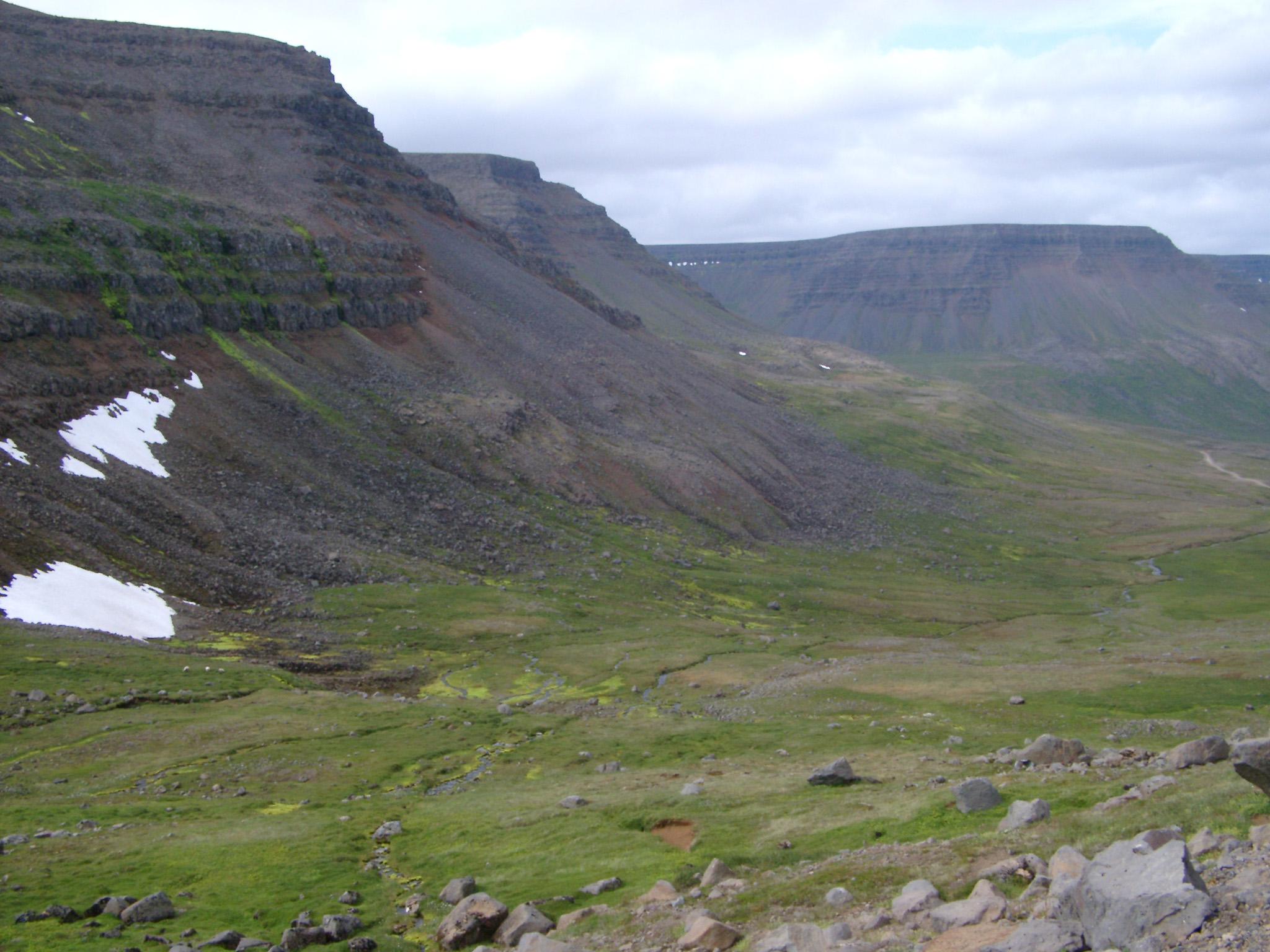 an image of Attractive Hills and Landscape at Iceland Country on Very Light Blue Sky Background.